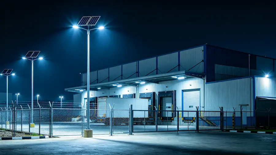 Solar street lights Nigeria — industrial warehouse perimeter with security lighting